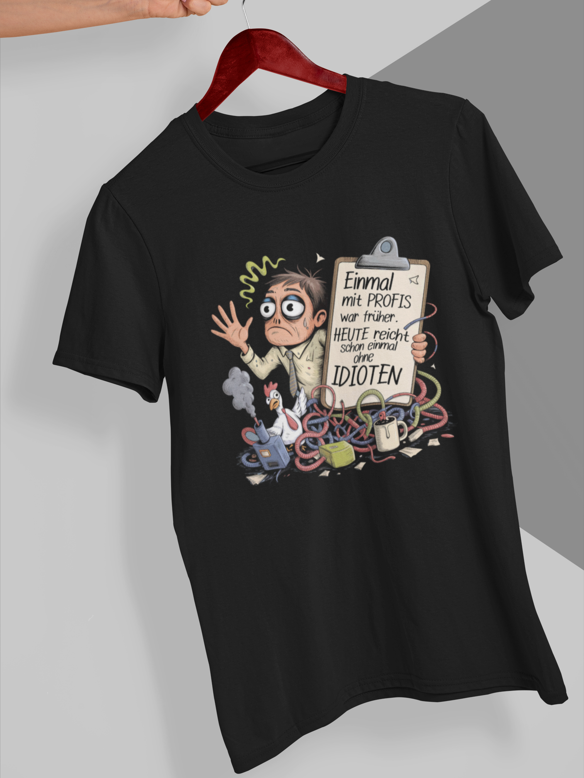 Schwarzes T-Shirt auf Kleiderbügel mit weißem Text „Einmal mit Profis war früher – Heute reicht schon einmal ohne Idioten“